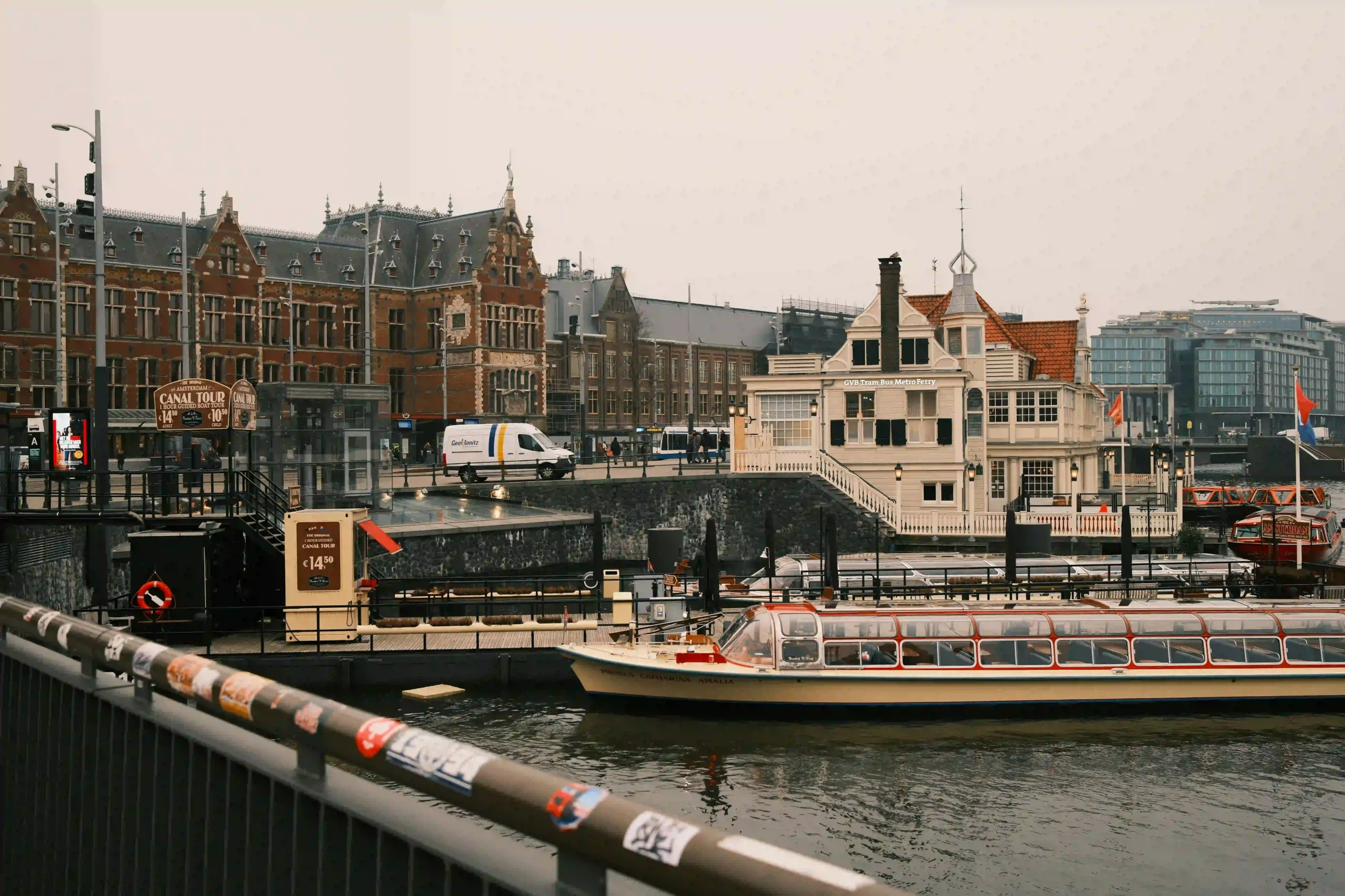 Amsterdam canal with boats and historic buildings near central station, Netherlands