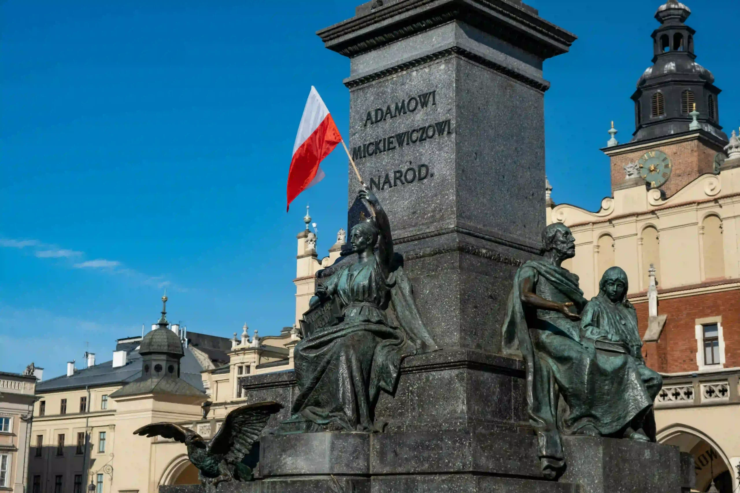 Adam Mickiewicz monument in Krakow Main Square with Polish flag, Poland