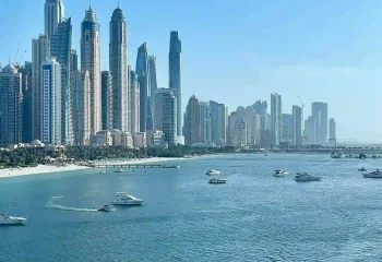 Dubai Marina skyline with skyscrapers and boats along the coast, UAE